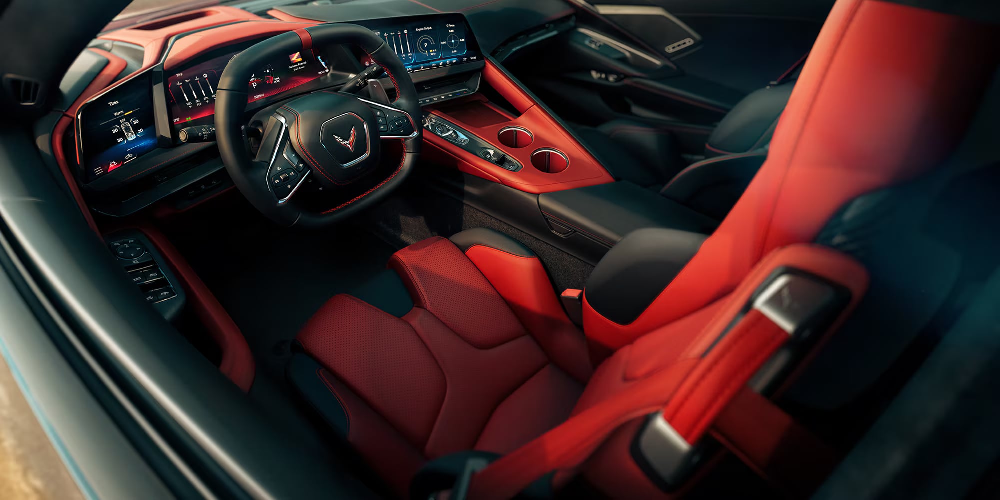 Modern red and black sports car interior featuring a digital driver cockpit and sport bucket seats.