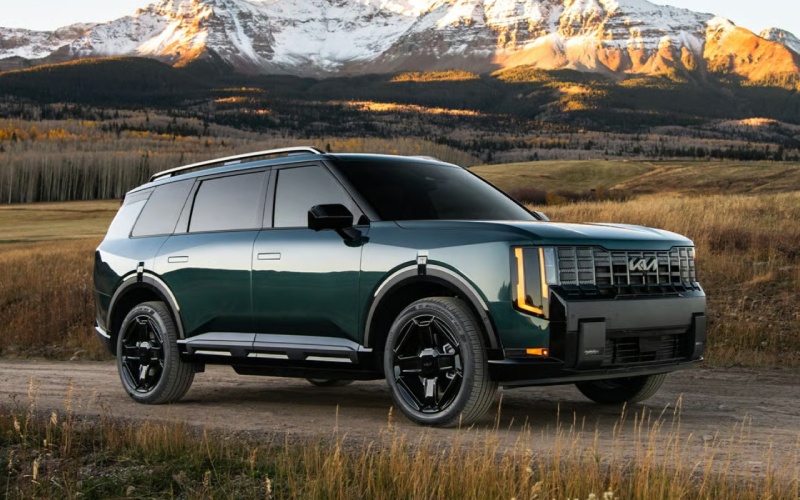 Dark green Kia SUV on a mountain road