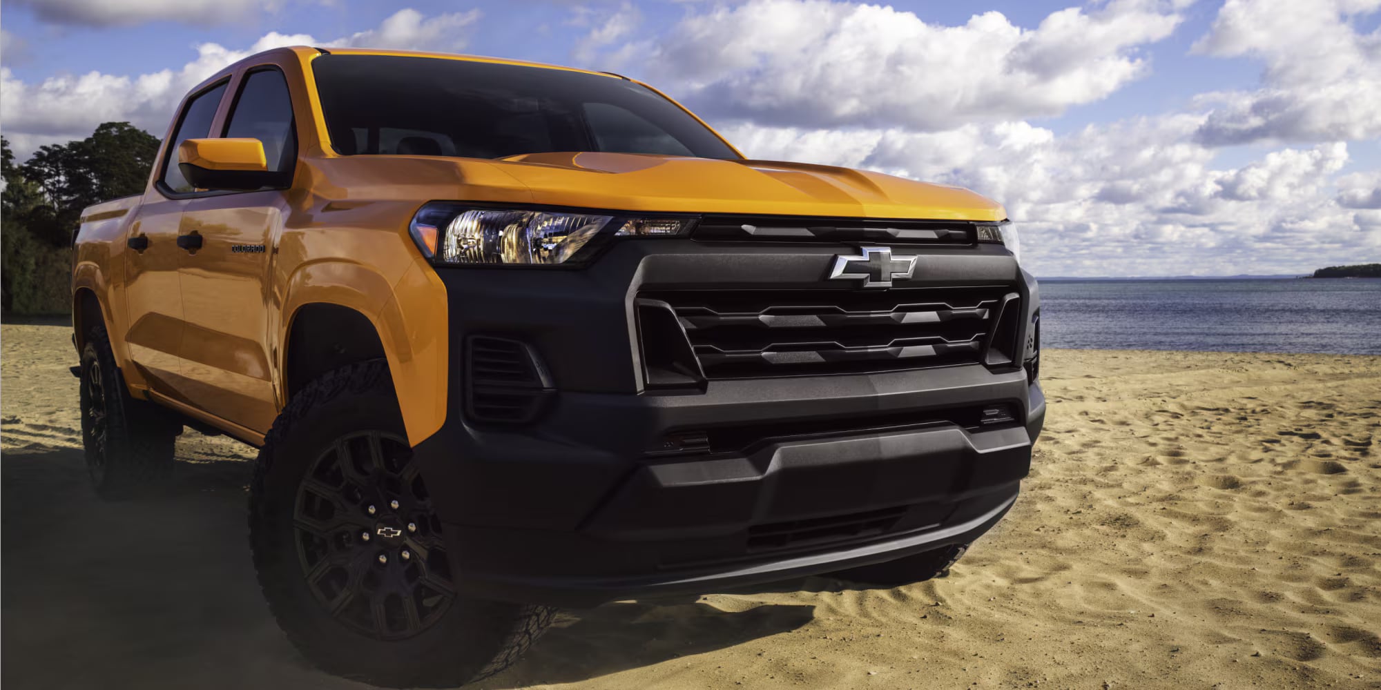 Orange Chevrolet Colorado parked near the water