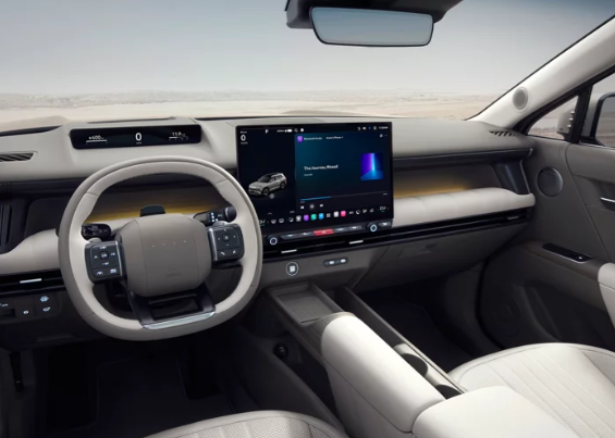 Modern electric vehicle interior featuring a large central touchscreen, slim digital gauge display, and light beige trim.