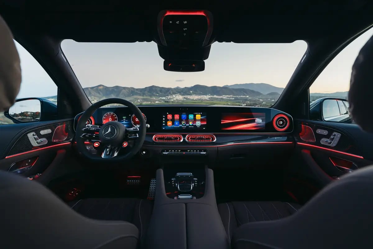 Mercedes-AMG interior with ambient lighting and digital dashboard displays.