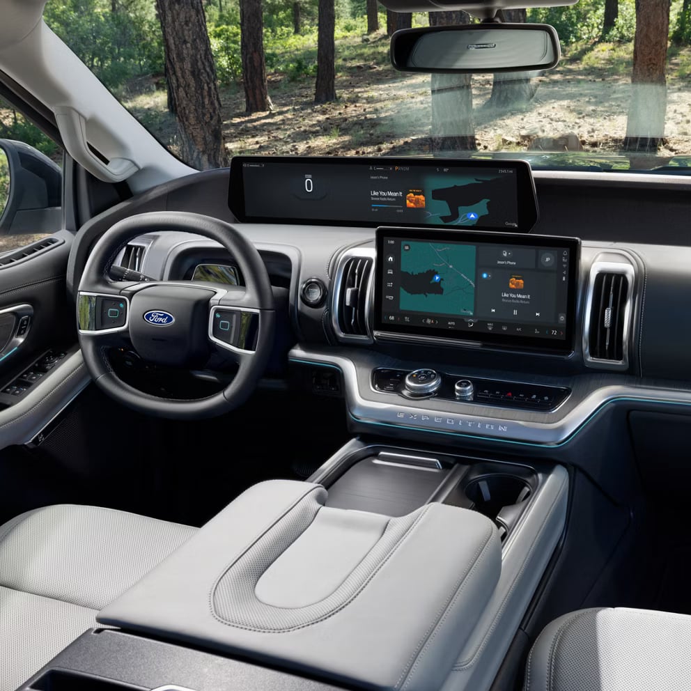 High-tech interior of a Ford Expedition featuring a dual-screen digital dashboard, steering wheel, and center console.