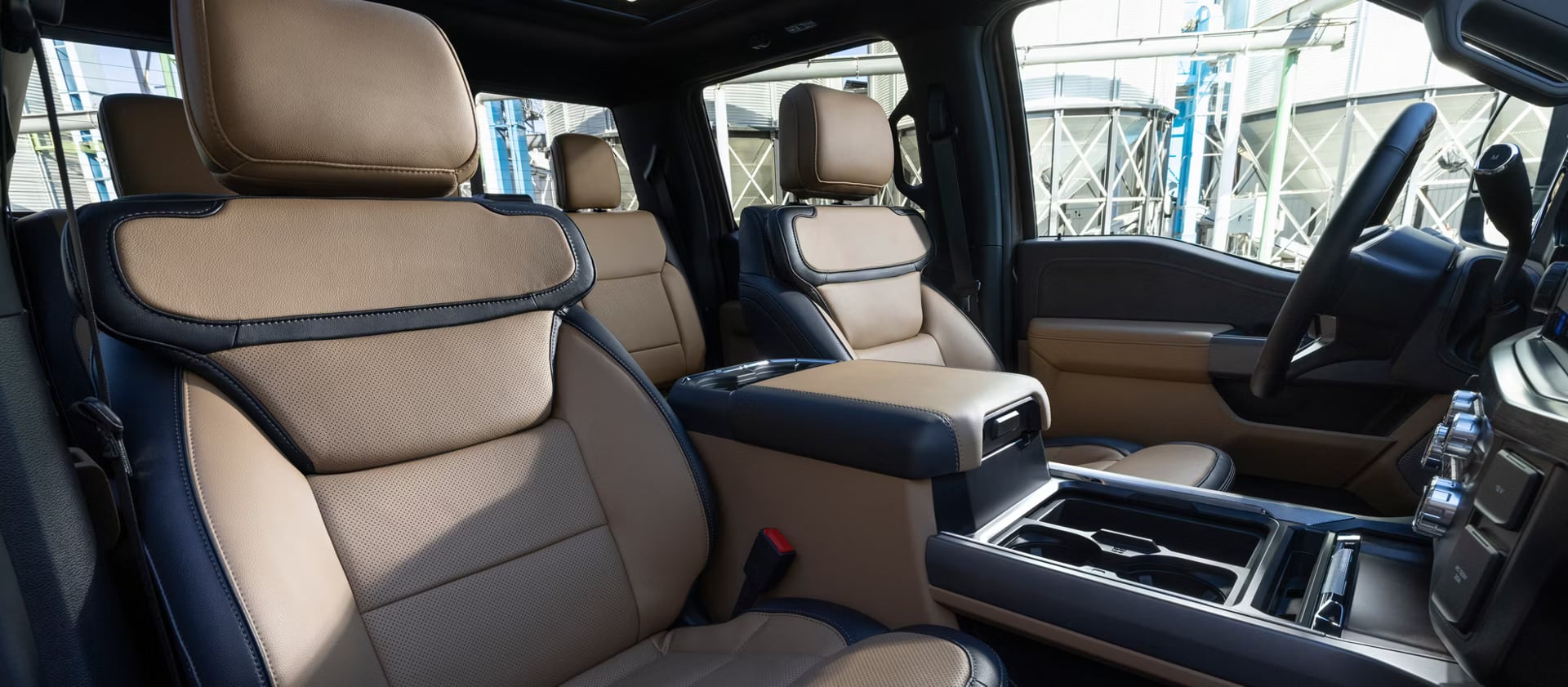 Tan and dark navy leather seats and center console inside a luxury pickup truck cabin.