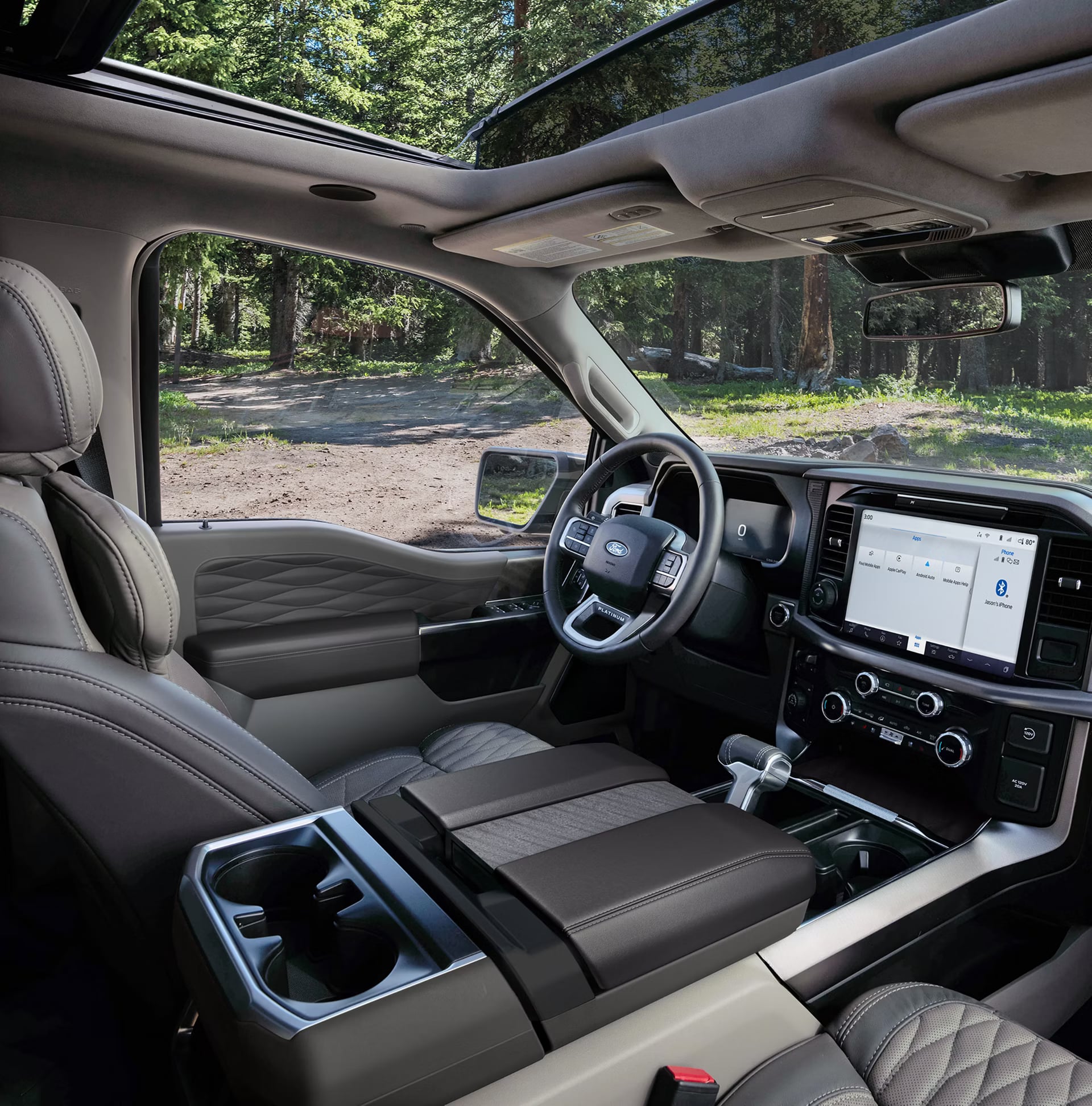 Interior view of a modern Ford F-150 Platinum truck featuring leather seats, a digital dashboard, and panoramic sunroof.