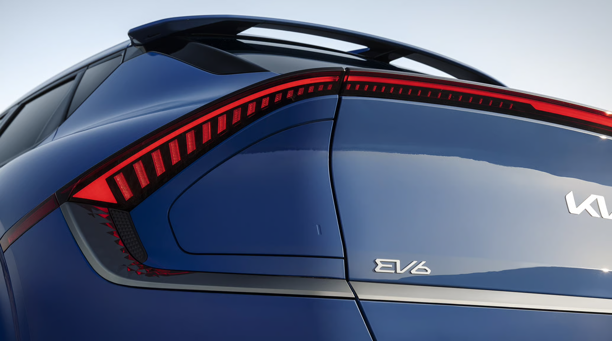 Rear LED taillight and emblem on a blue Kia EV6.