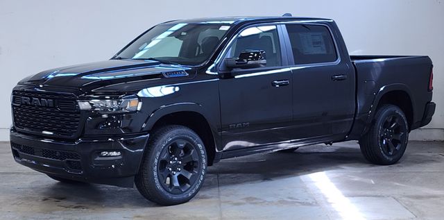 Black RAM 1500 crew cab pickup truck with black wheels parked in a showroom.