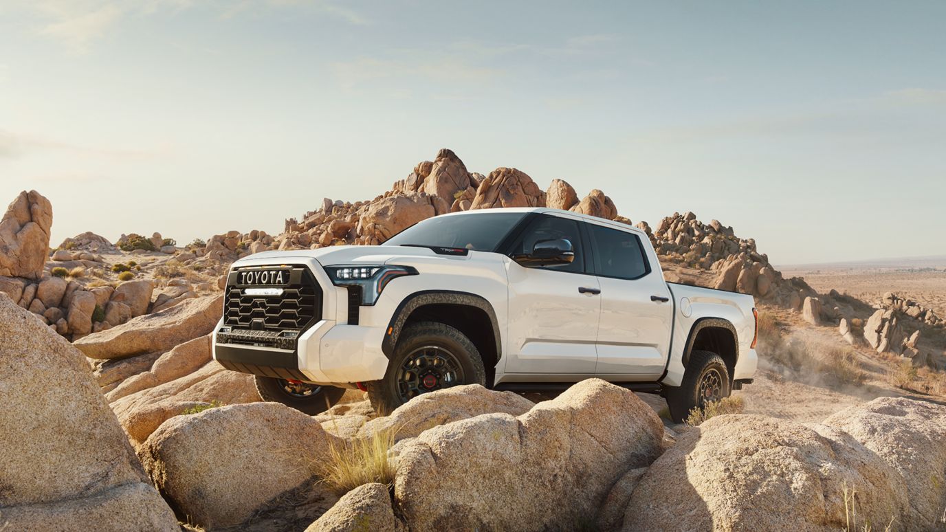 A white Toyota Tundra parked on a rocky hill.