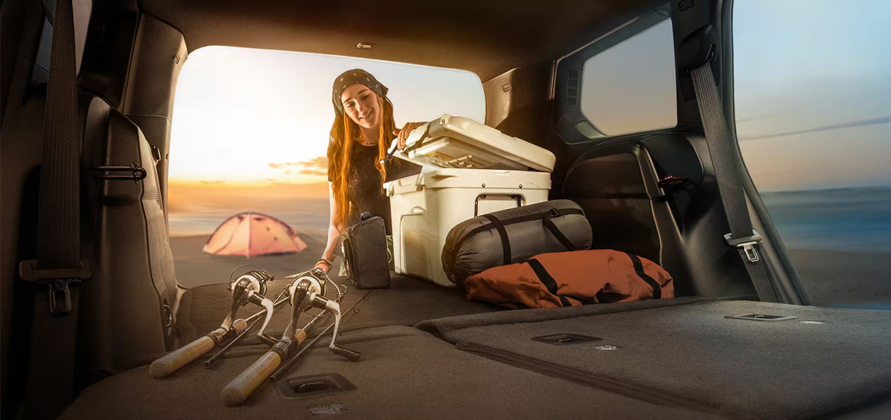 Cooler and outdoor gear being loaded into an SUV