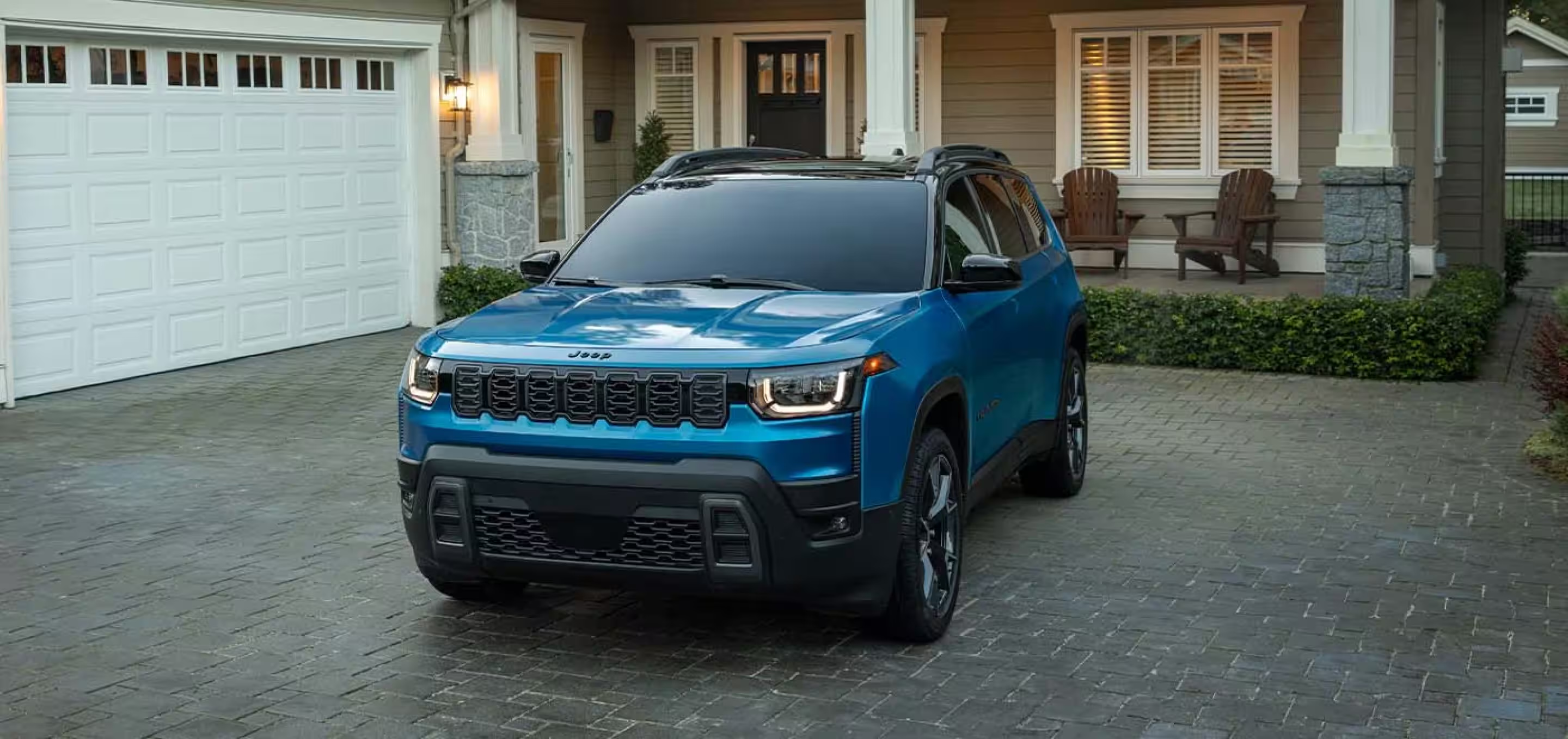 Blue Jeep SUV parked outside a home