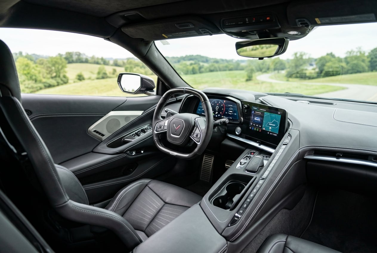 2027 Chevrolet Corvette interior, driver-focused cockpit with luxurious leather sport seats, digital gauge cluster and center console, soft natural light with blurred Kentucky countryside through the windshield, realistic automotive interior photography, no people, no text or logos (Representative image for illustration purposes only. Actual vehicle may vary based on trim and configuration.)