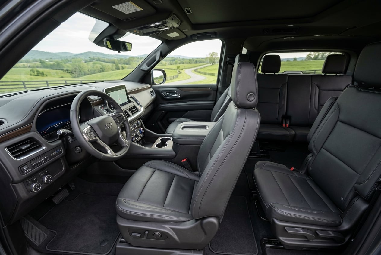 2027 Chevrolet Suburban interior, wide view of the spacious three-row cabin with premium leather seats and modern dashboard, soft natural light with Kentucky countryside visible through the windows, realistic automotive interior photography, no people, no text or logos (Representative image for illustration purposes only. Actual vehicle may vary based on trim and configuration.)