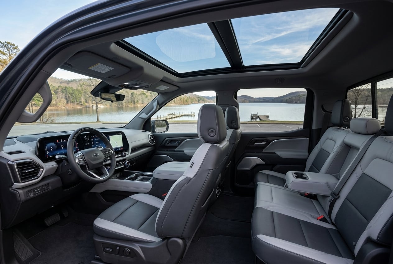 Interior of the 2027 Chevrolet Silverado EV crew cab showing spacious front and rear seats, large dashboard touchscreen and panoramic glass roof, parked at a lakeside park in Guntersville, Alabama, soft daylight, realistic photo, no people, no text or logos (Representative image for illustration purposes only. Actual vehicle may vary based on trim and configuration.)