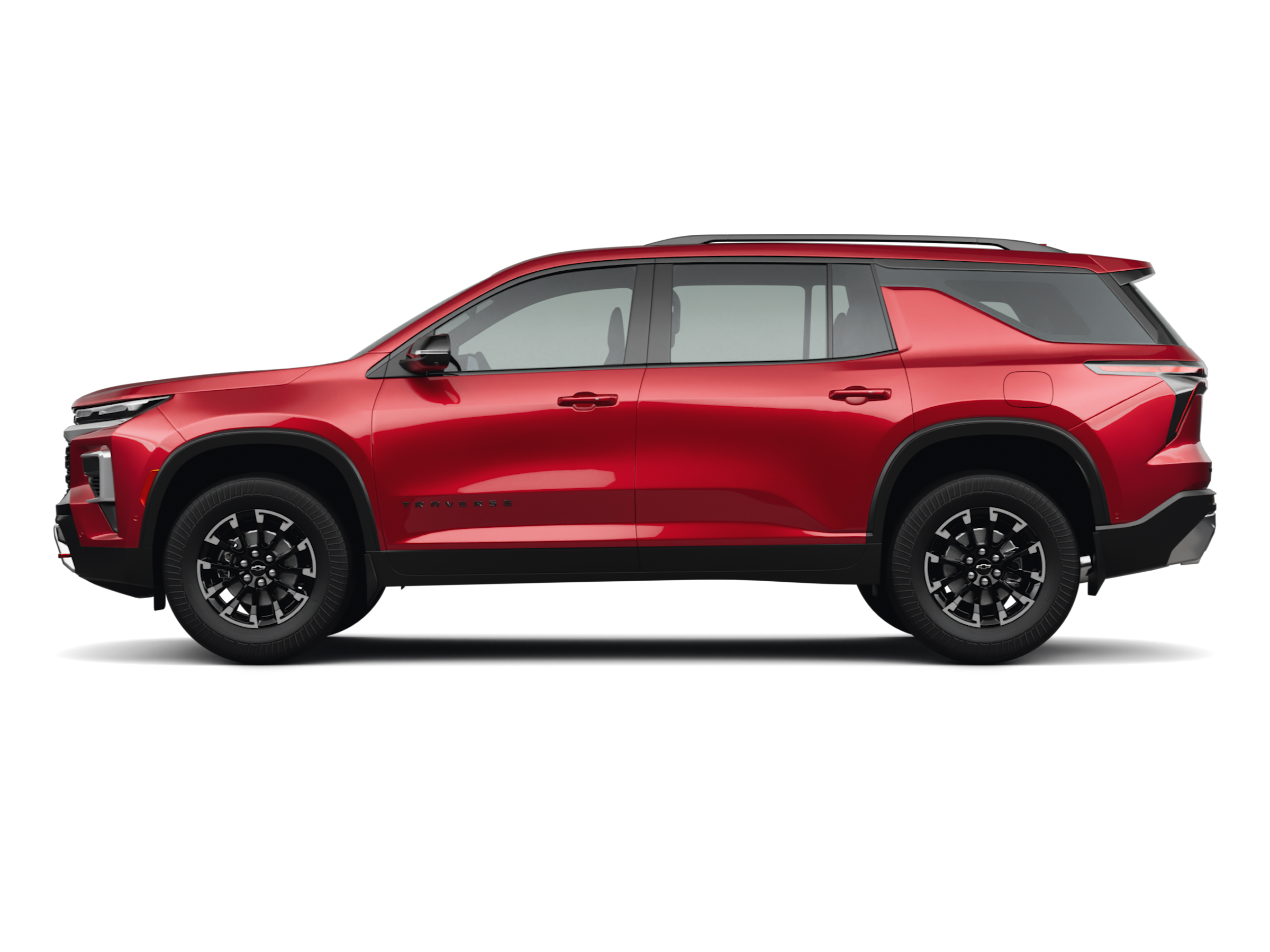 A white Chevrolet Traverse with three rows of seating