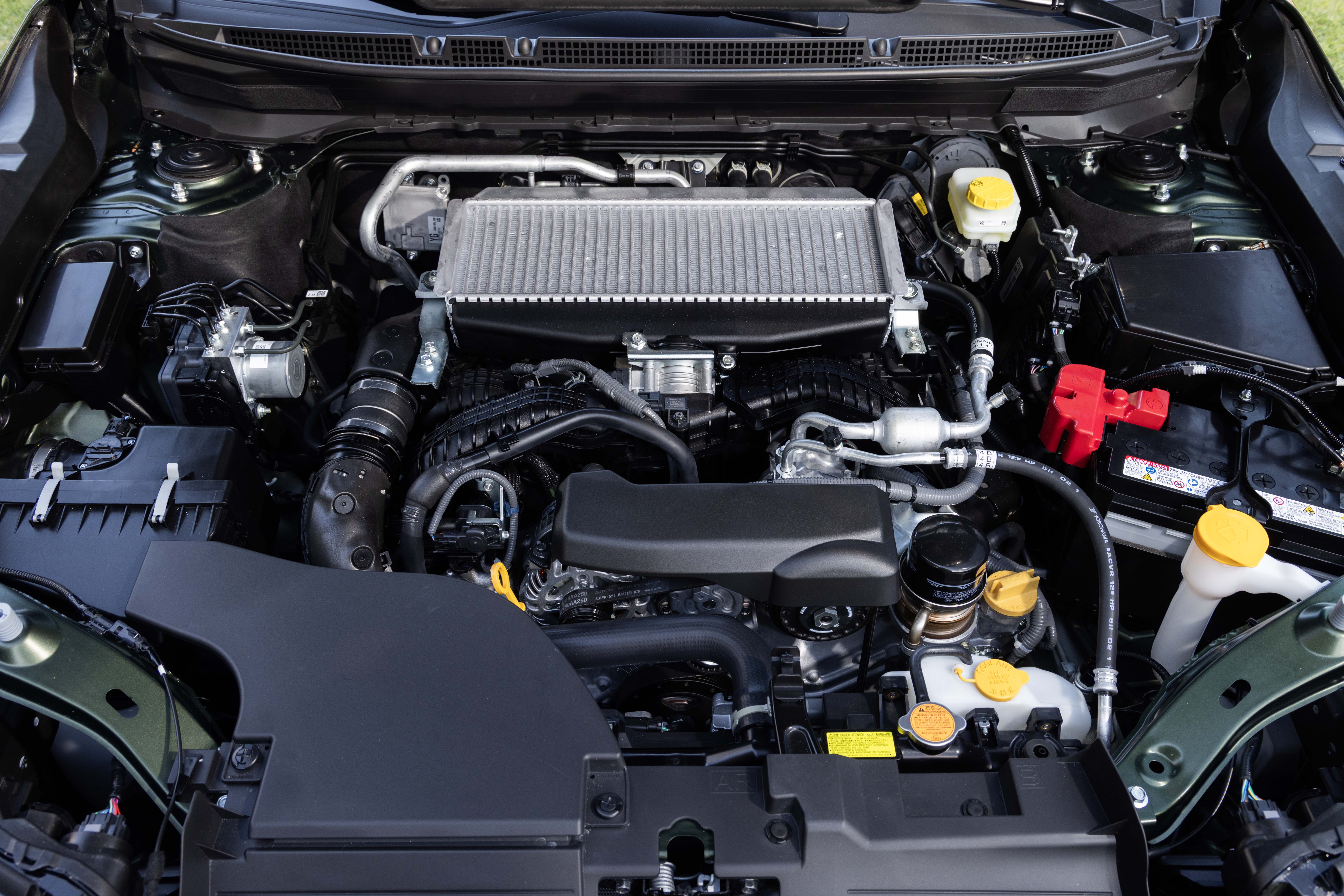 Overhead view of a clean car engine bay featuring a top-mounted intercooler and fluid reservoirs.