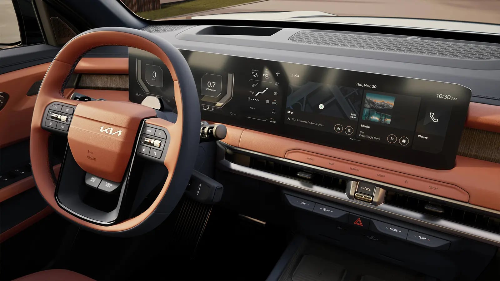 Interior view of a modern Kia vehicle featuring a two-tone steering wheel, digital dashboard screen, and tan leather trim.