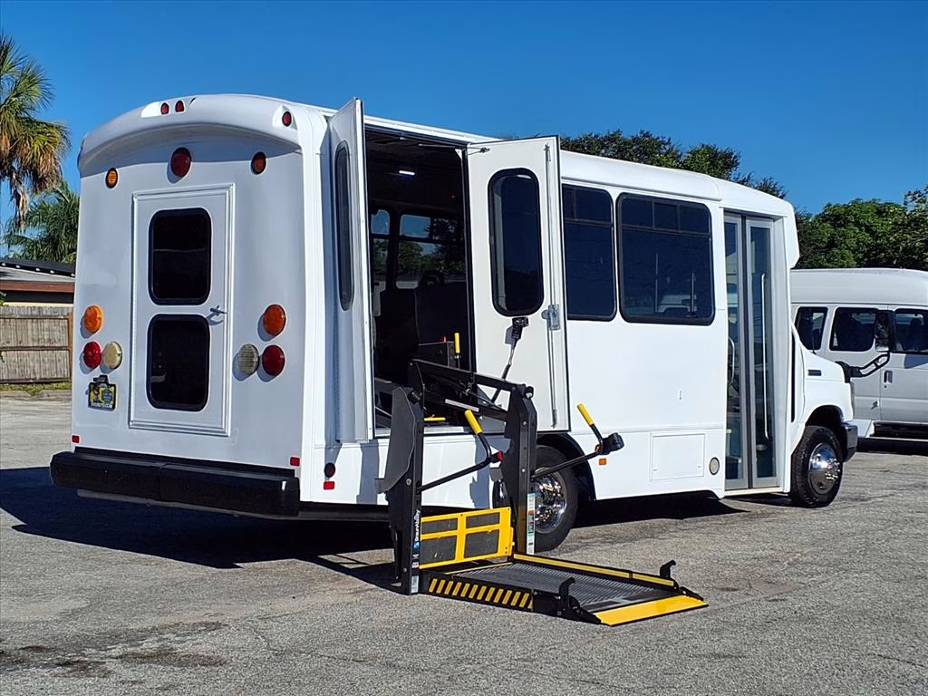 A group of happy passengers boarding a shuttle bus.
