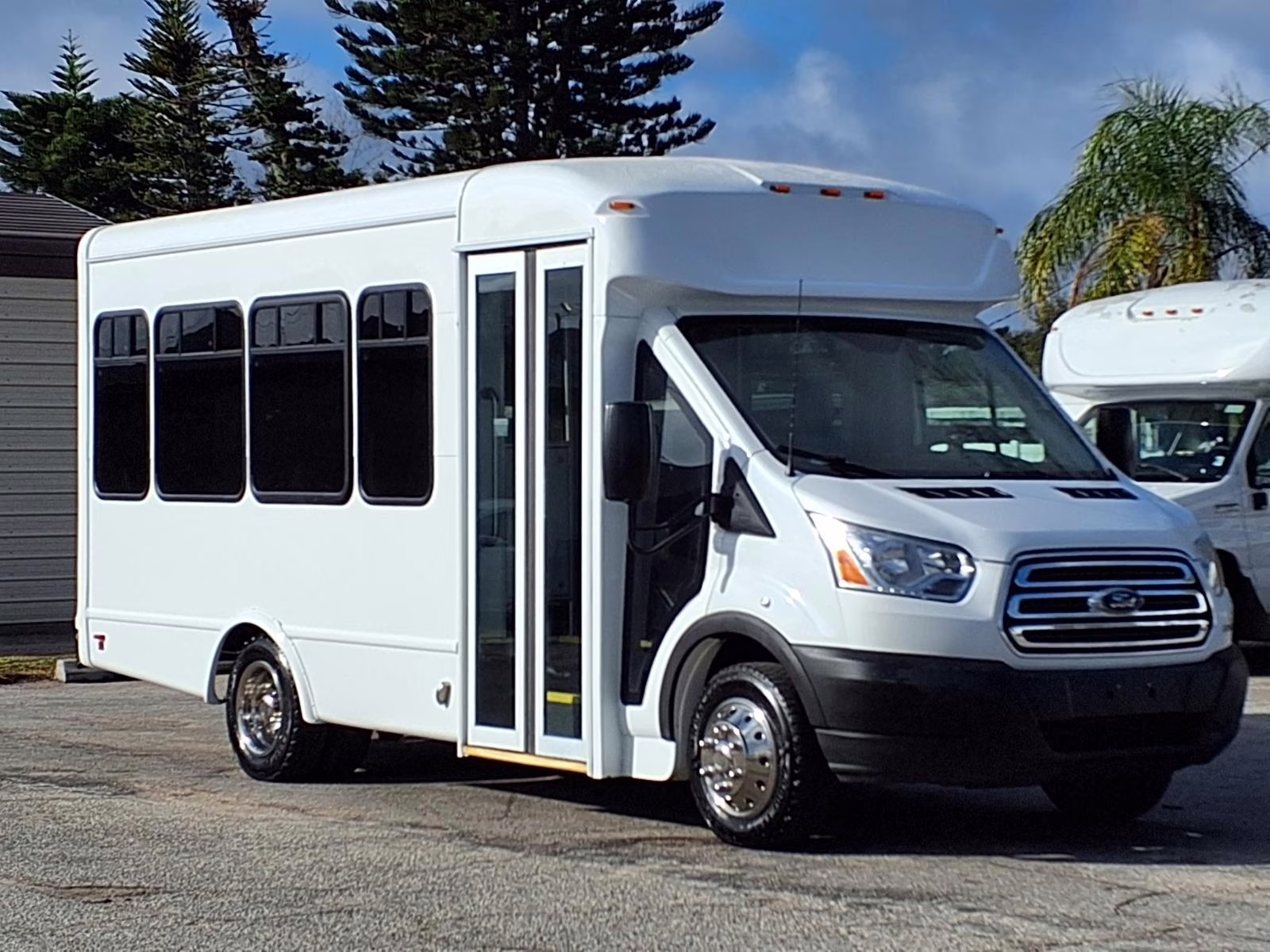 A shuttle bus with an ADA wheelchair lift deployed.