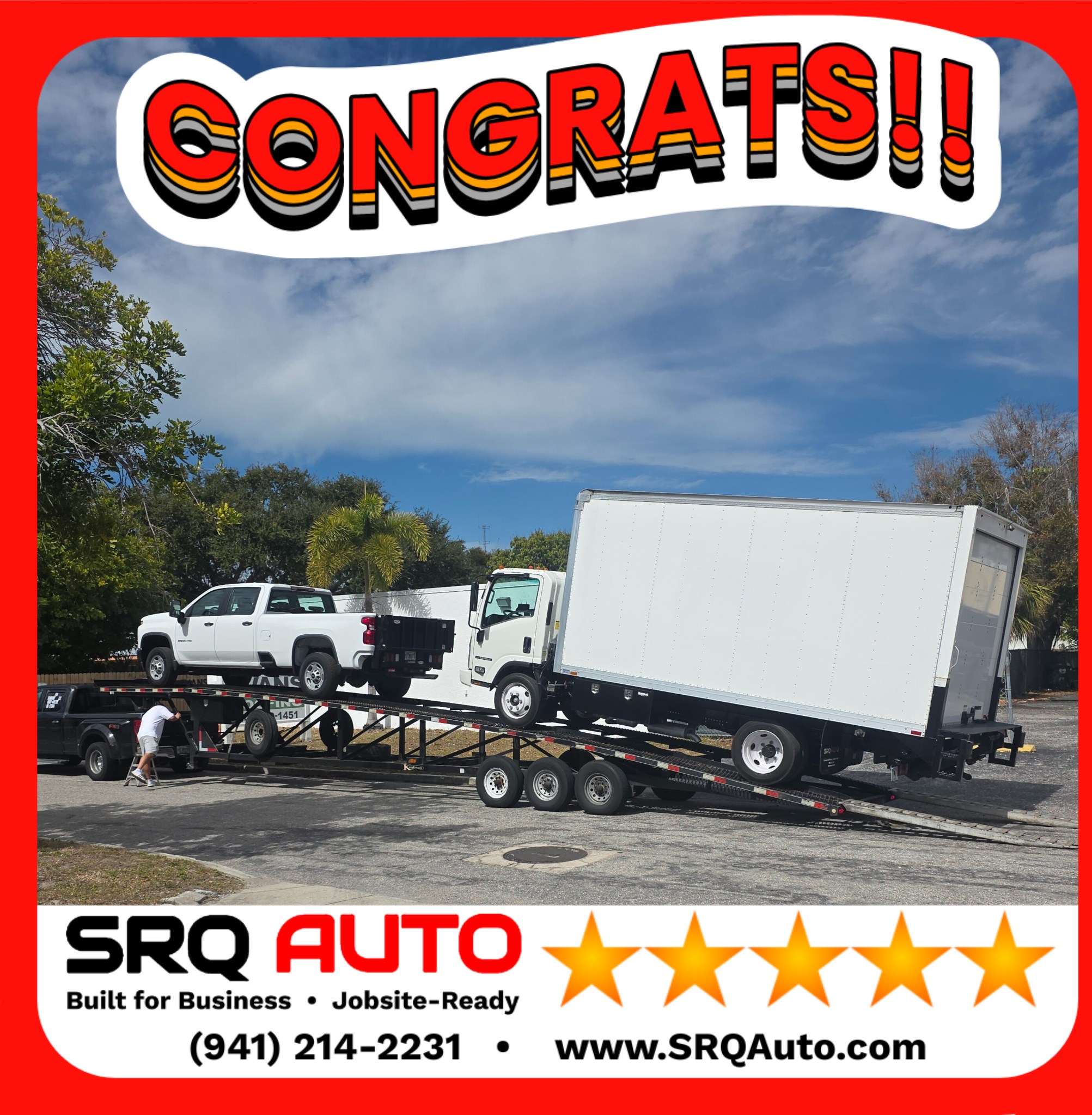 A professional box truck being loaded onto a transport trailer for nationwide delivery