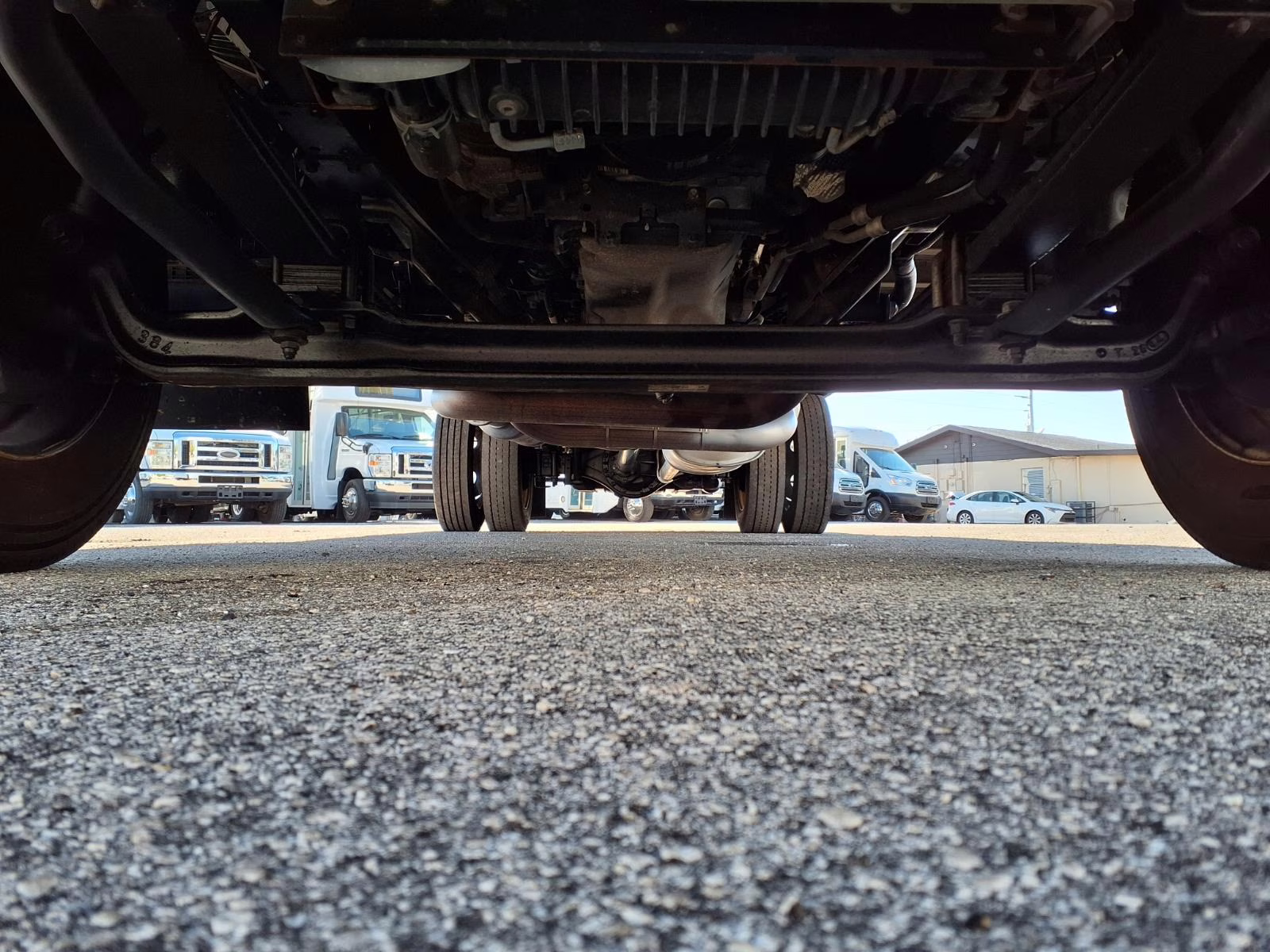 A close-up shot of a rust-free commercial truck frame and suspension