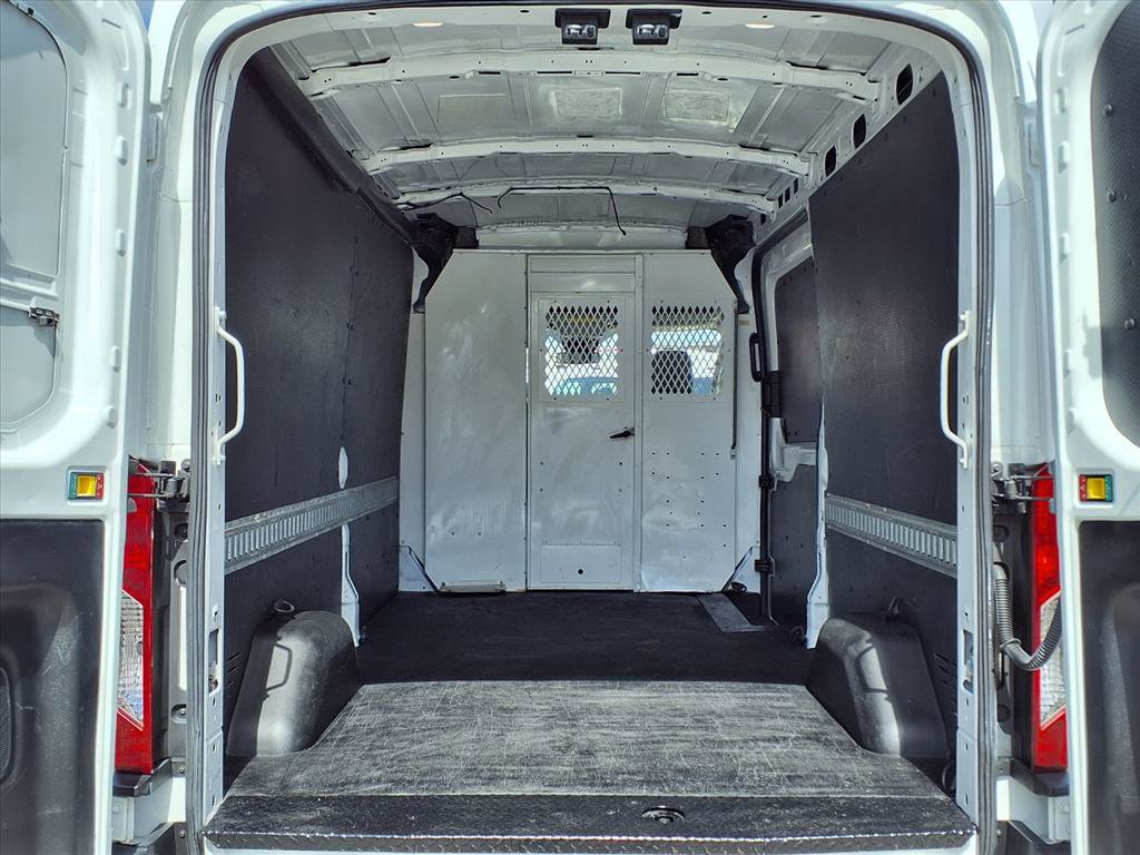Interior view of a Ford Transit cargo van showing organized shelving and ample space for tools.