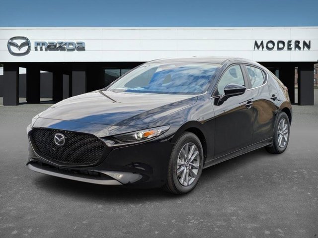 Black Mazda 3 hatchback parked in front of Modern Mazda dealership.