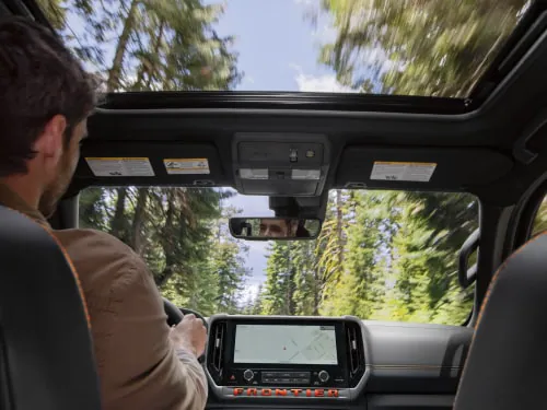Close up of the refined 2026 Nissan Frontier interior featuring the new 12.3-inch touchscreen and power seats