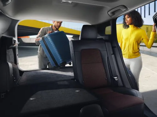 Interior view showing the cargo area with rear seats folded flat, highlighting the massive 60.0 cubic feet of space.