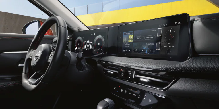 The modern dashboard of the 2026 Kicks featuring the standard 12.3-inch touchscreen and digital instrument cluster.