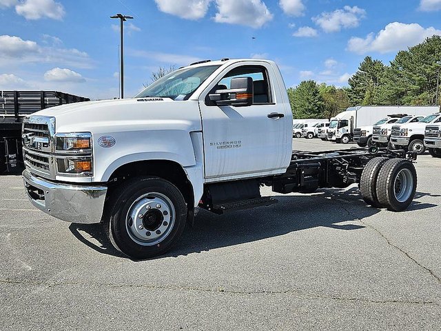A 2024 Chevrolet Silverado 6500 HD Chassis Cab shown in a professional commercial setting highlighting its massive scale and durable construction.