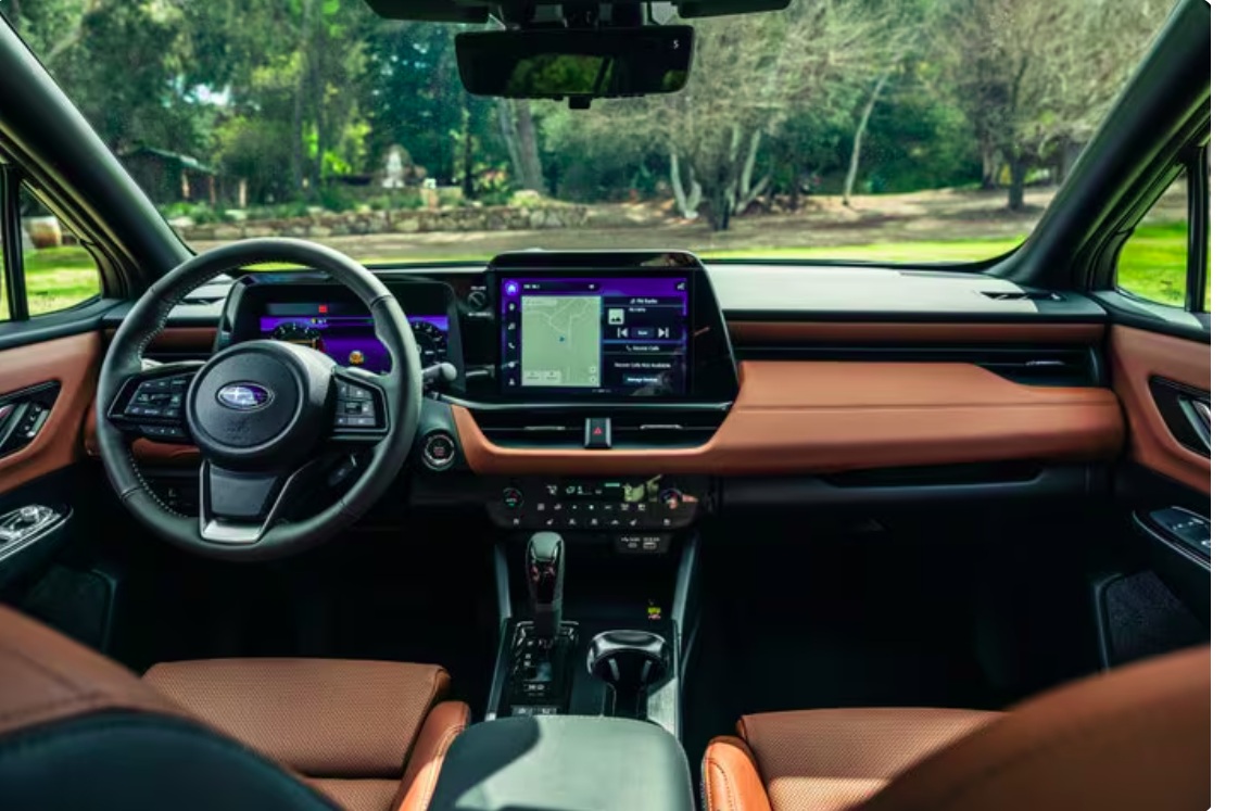 Interior view of a modern Subaru dashboard with brown leather seats and a large touchscreen display.