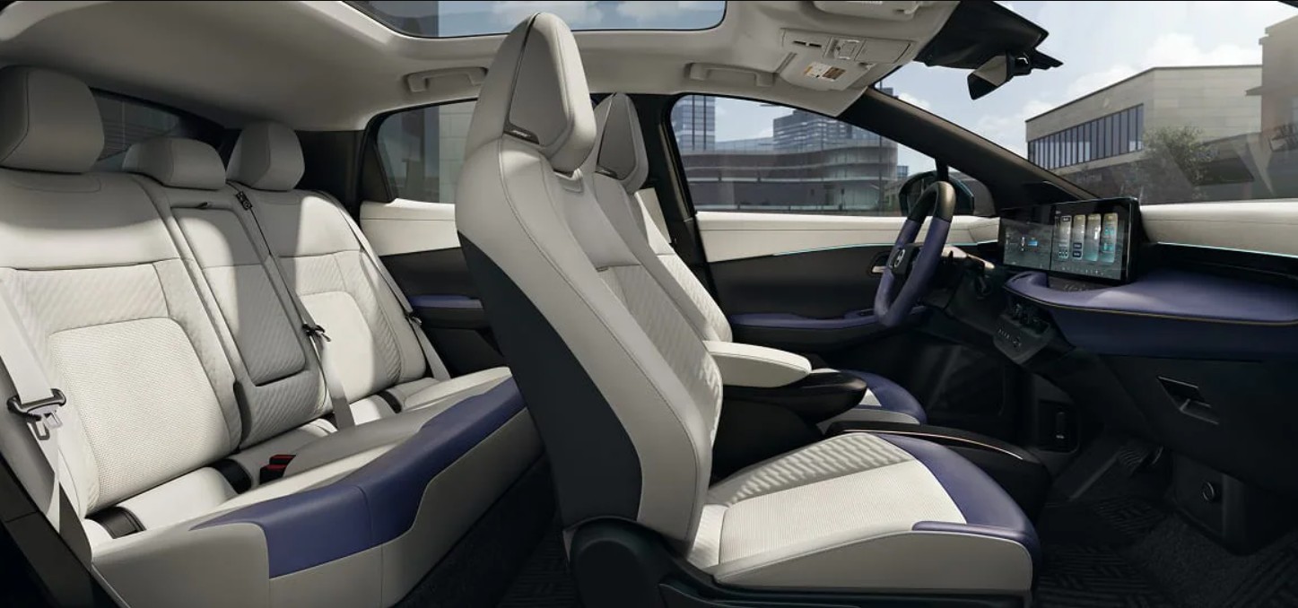 Interior view of a modern SUV featuring white leather seats with blue accents and a panoramic sunroof.