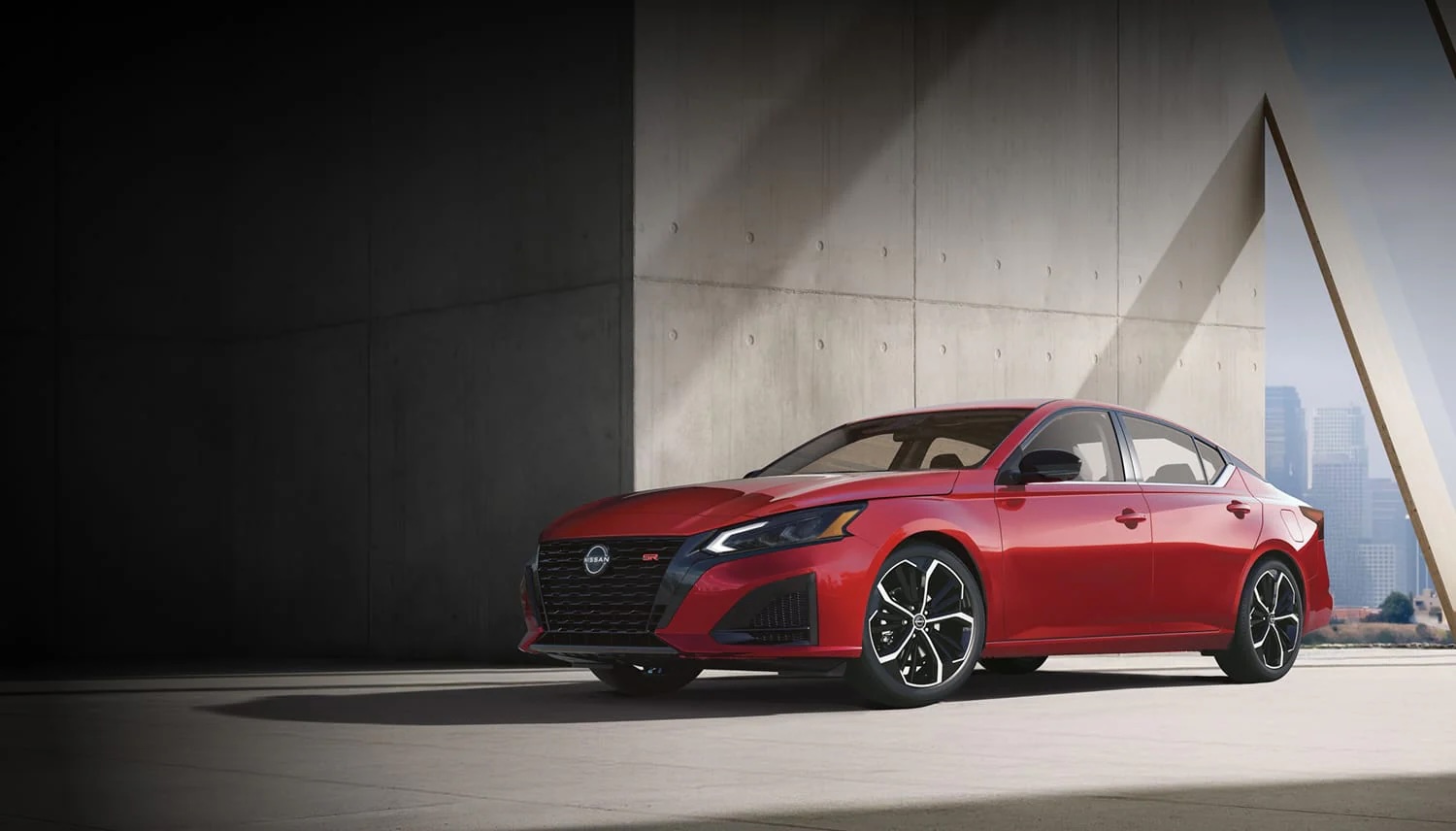 Red Nissan Altima SR parked outside a modern building