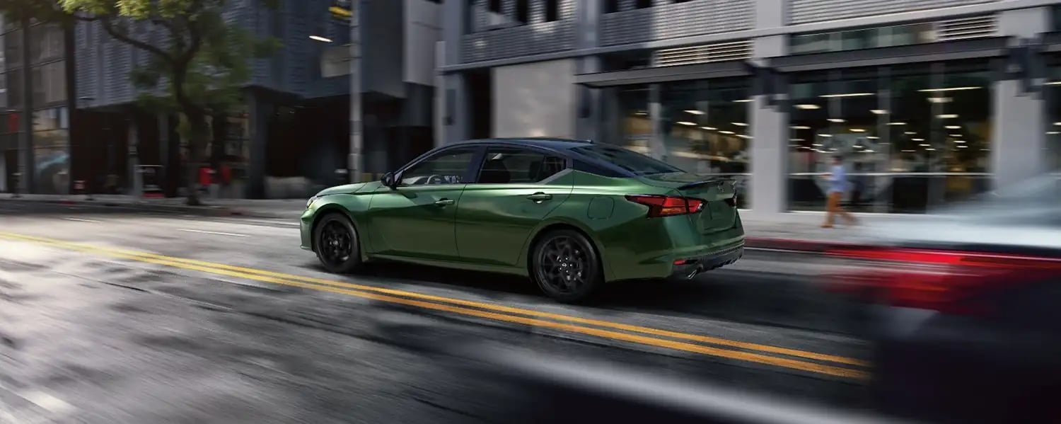 Nissan Altima driving through a city