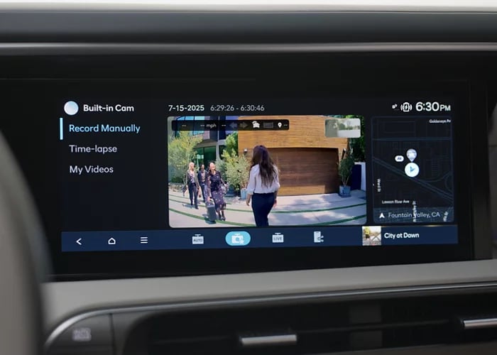 A car's dashboard infotainment display showing the Built-in Cam feature with a video playback and map.