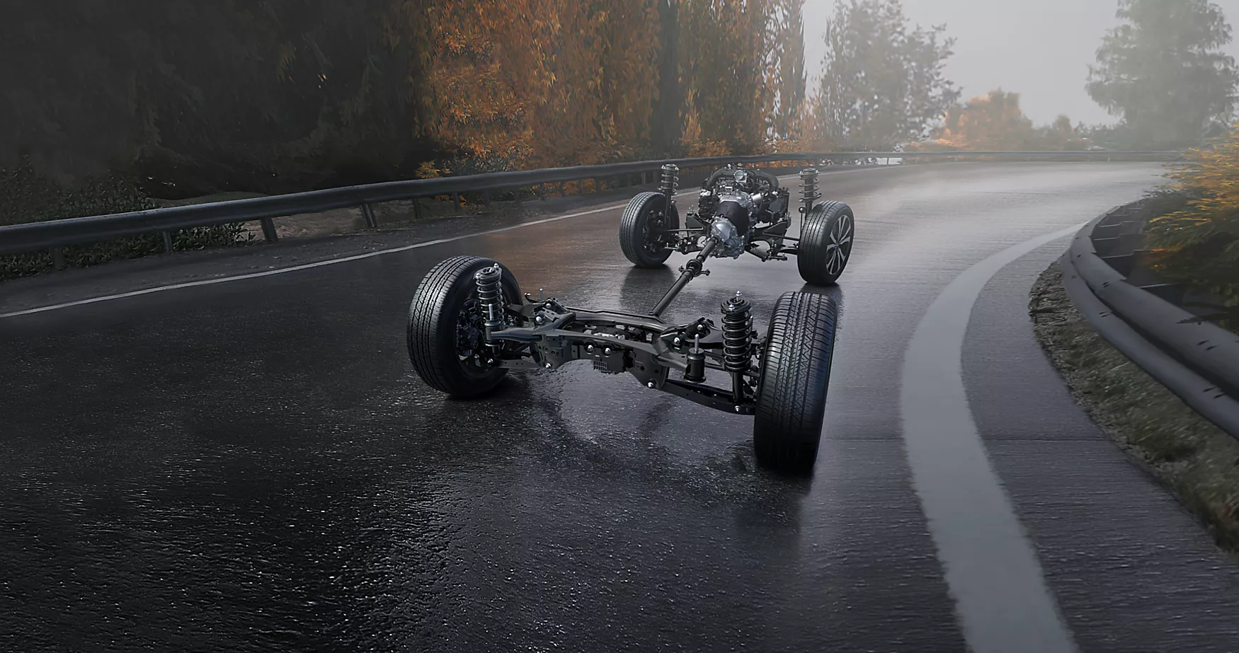Exposed vehicle chassis with engine and drivetrain on a wet, foggy forest road curve.