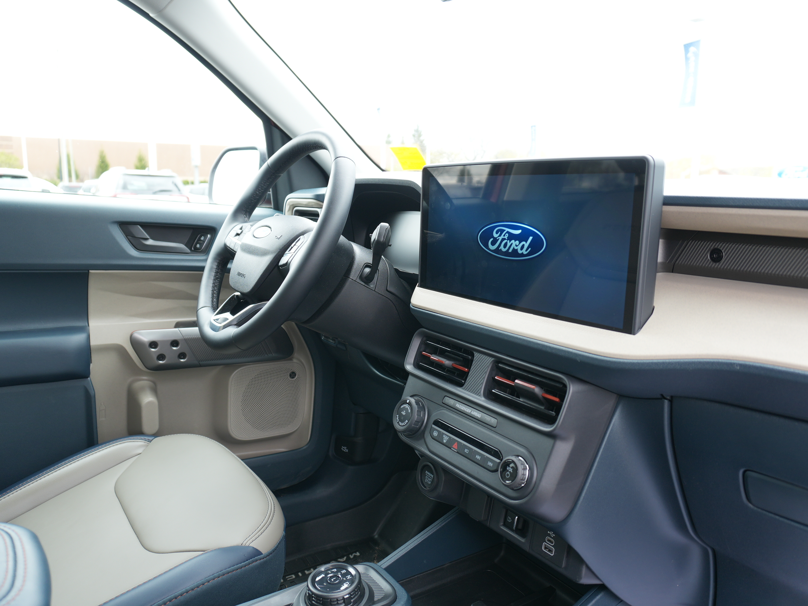 Interior dashboard view of a modern Ford vehicle showing the large infotainment screen and steering wheel.