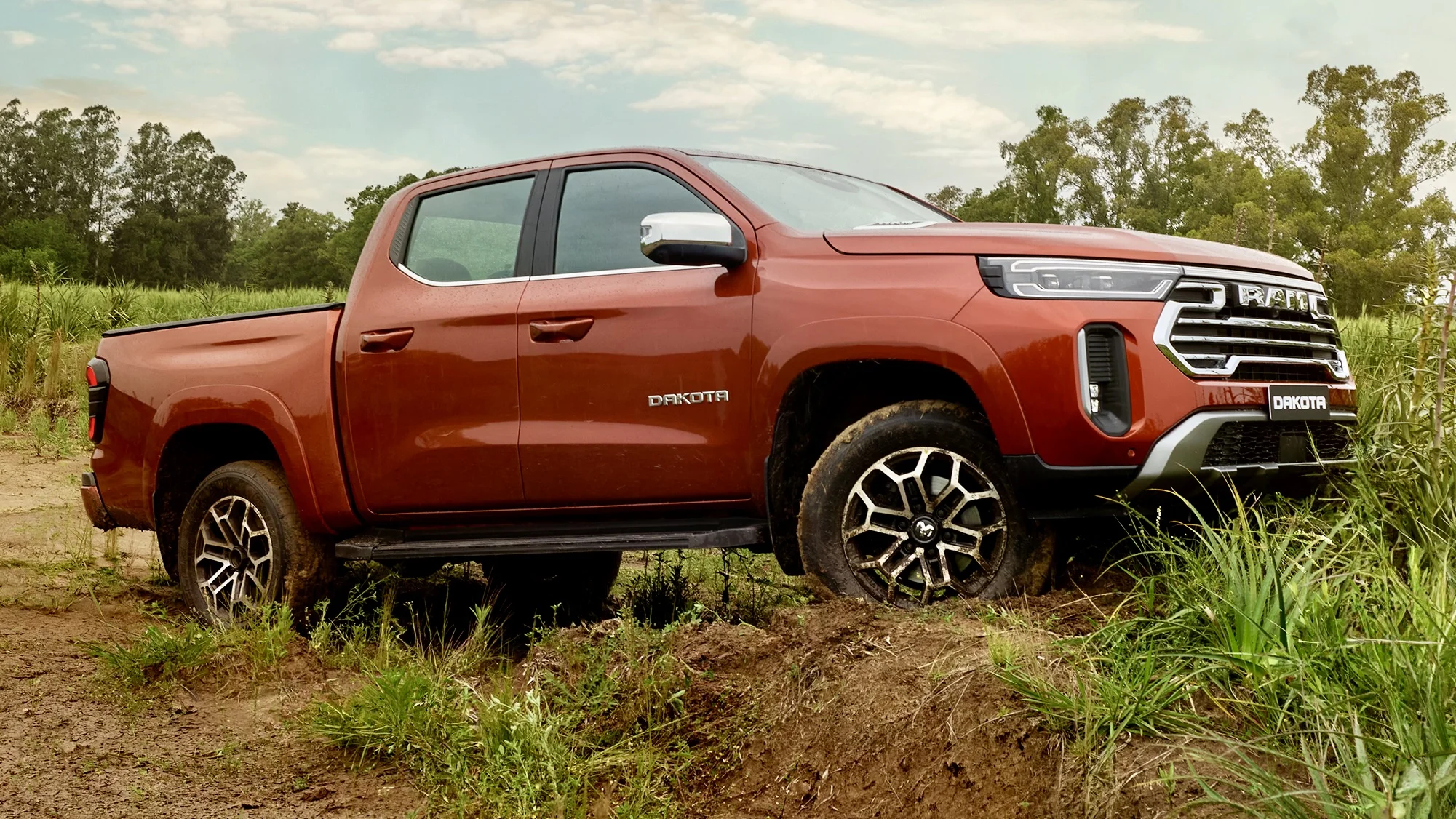 Ram Dakota pickup truck driving on dirt road.