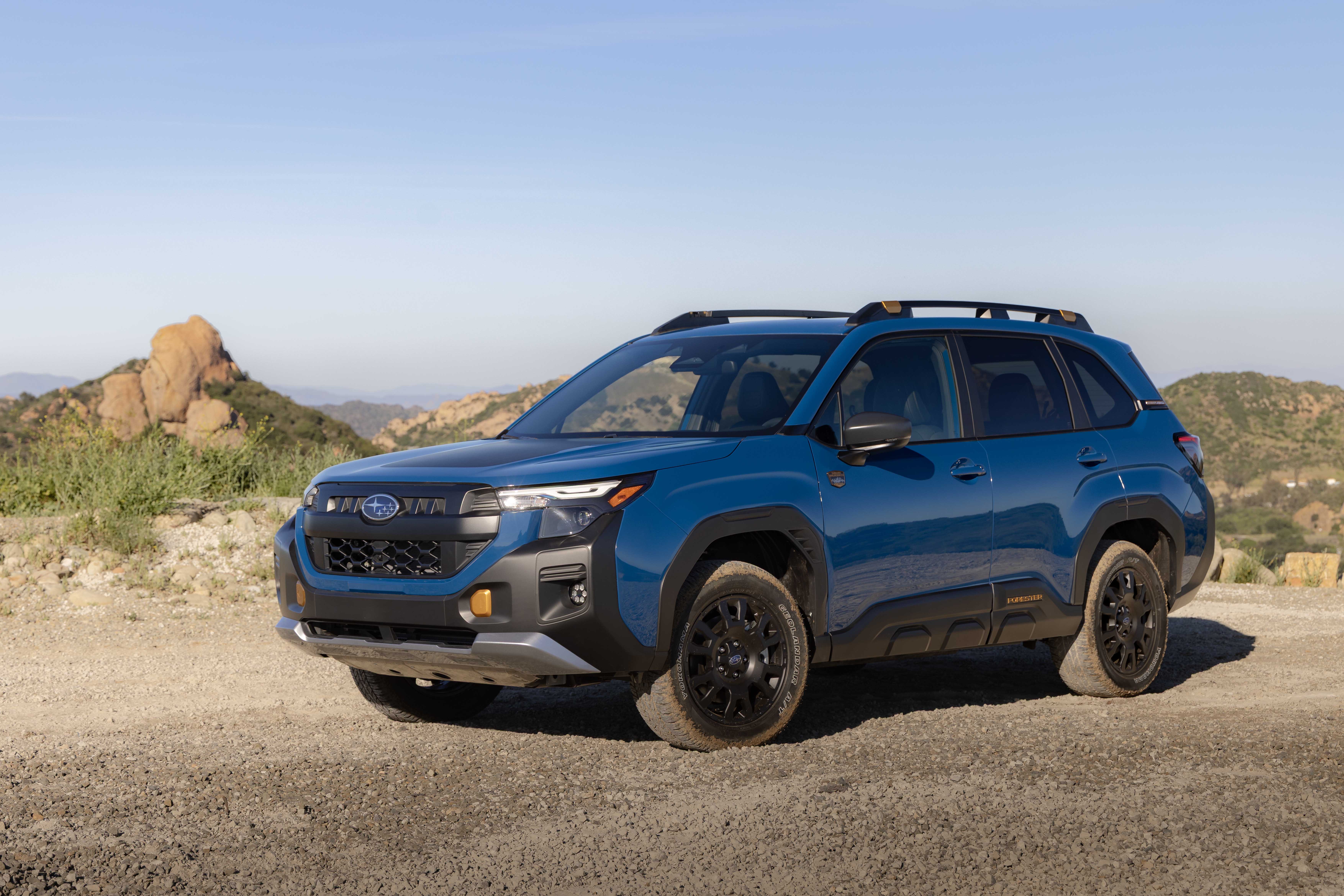 2027 Subaru Forester Hybrid Wilderness SUV parked on gravel road.