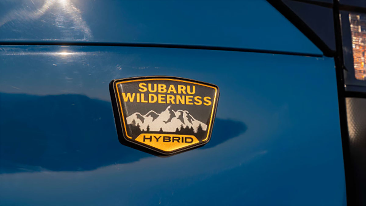 2027 Subaru Forester Wilderness Hybrid badge on blue vehicle exterior