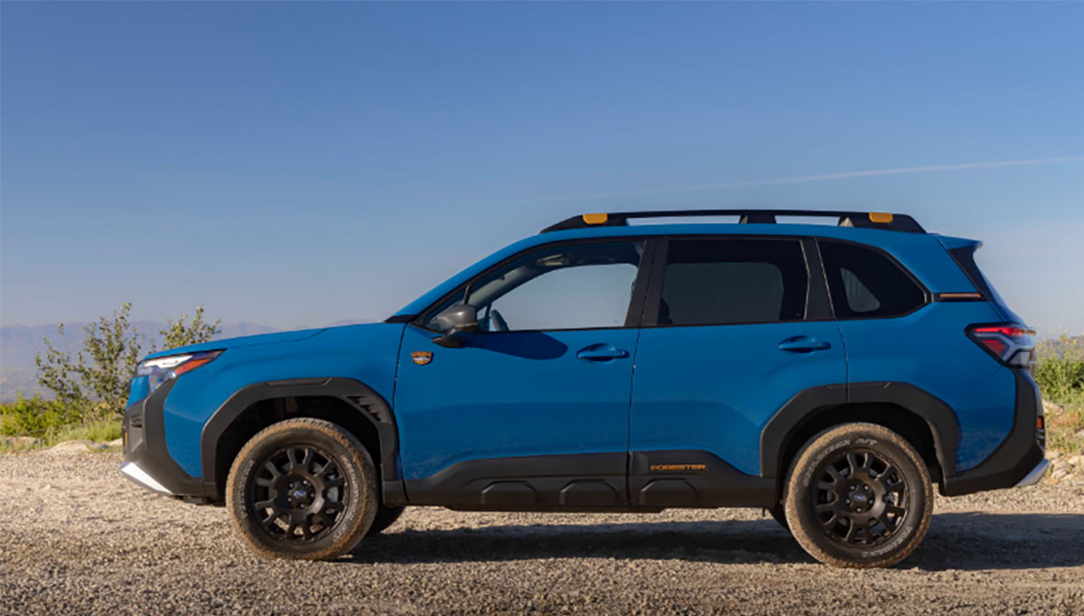 Blue 2027 Subaru Forester Hybrid Wilderness SUV on gravel road.