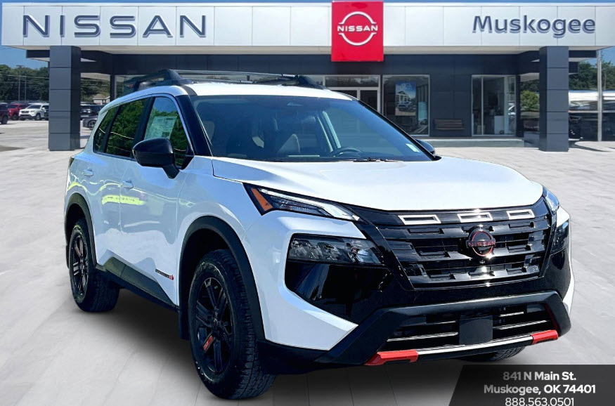 White Nissan Rogue Rock Creek parked in front of Nissan Muskogee dealership.
