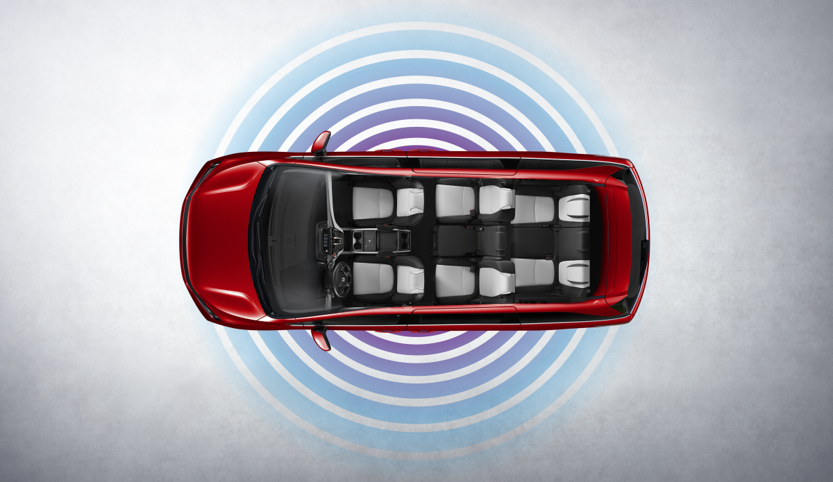 Overhead view of a red minivan with nine seats and blue concentric circles around it.