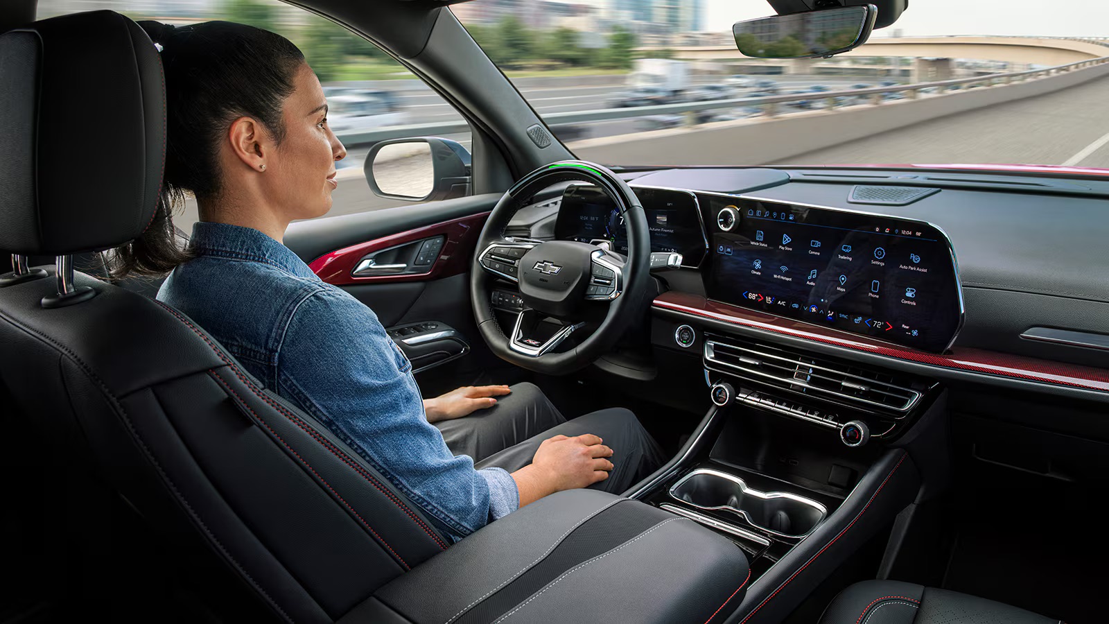 Woman driving a Chevrolet Traverse with available Super Cruise hands-free technology on a highway