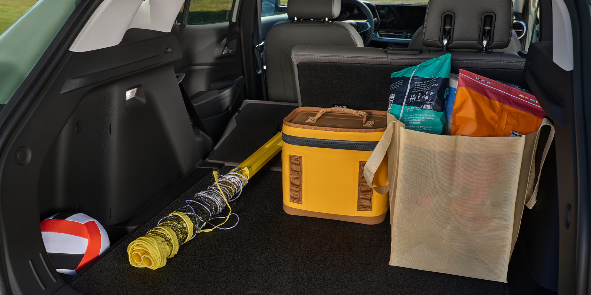 Open trunk of a Chevrolet Trax packed with recreation gear and cargo