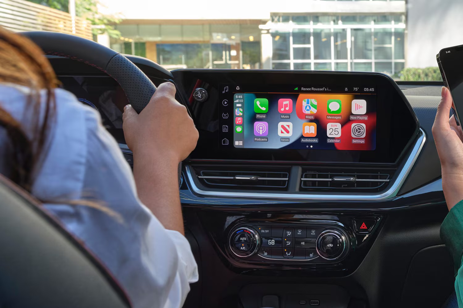 Driver using Apple CarPlay on the Chevrolet Trax infotainment screen