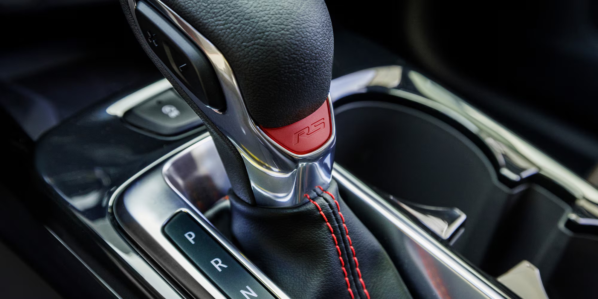 Close-up of a Chevrolet Trax gear shift lever with RS logo and red stitching