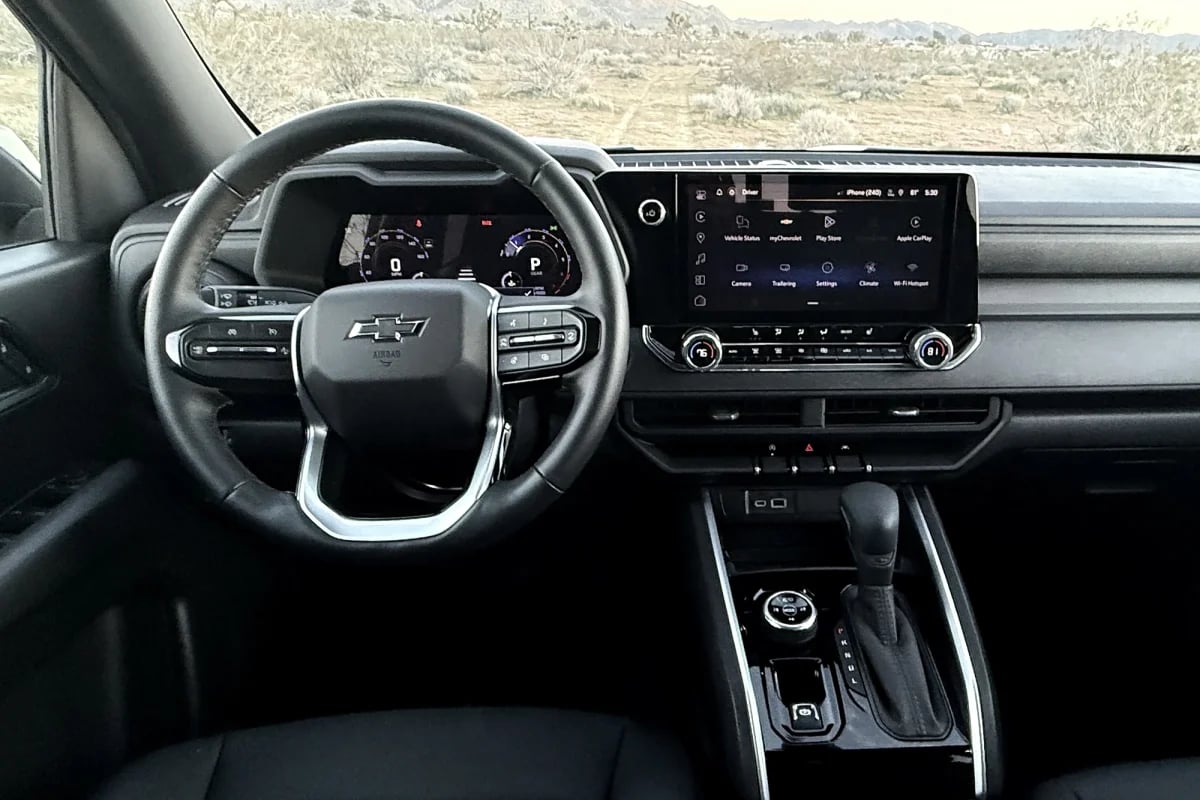 Interior view of a Chevrolet truck dashboard with a digital instrument cluster, touchscreen, and steering wheel.