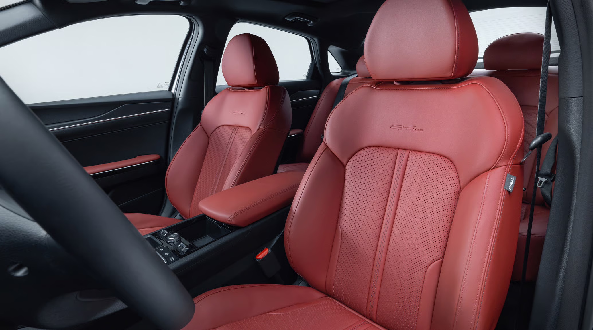 2026 Kia K5 interior with red seat trim and modern center console.