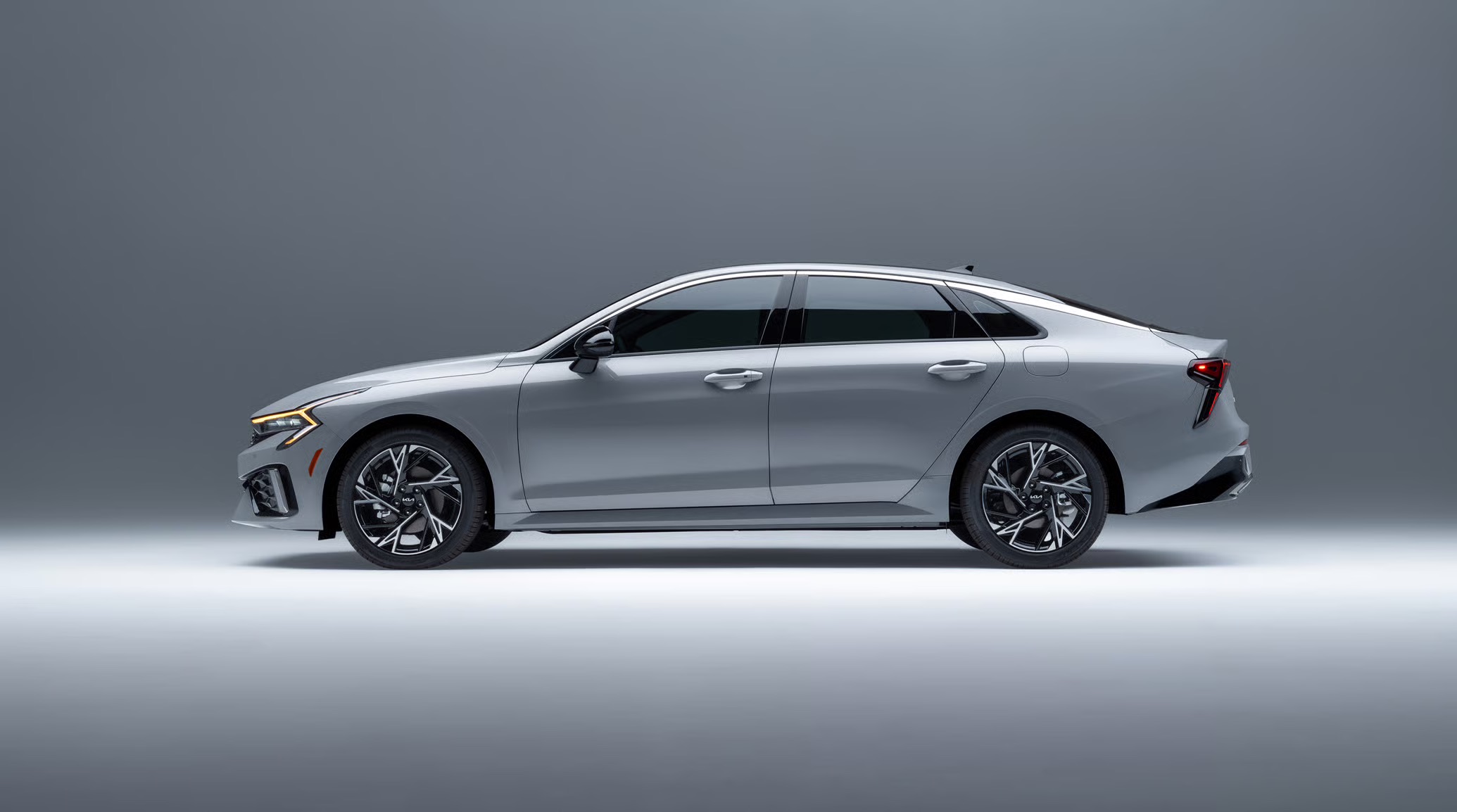Profile view of a silver 2026 Kia K5 sedan.
