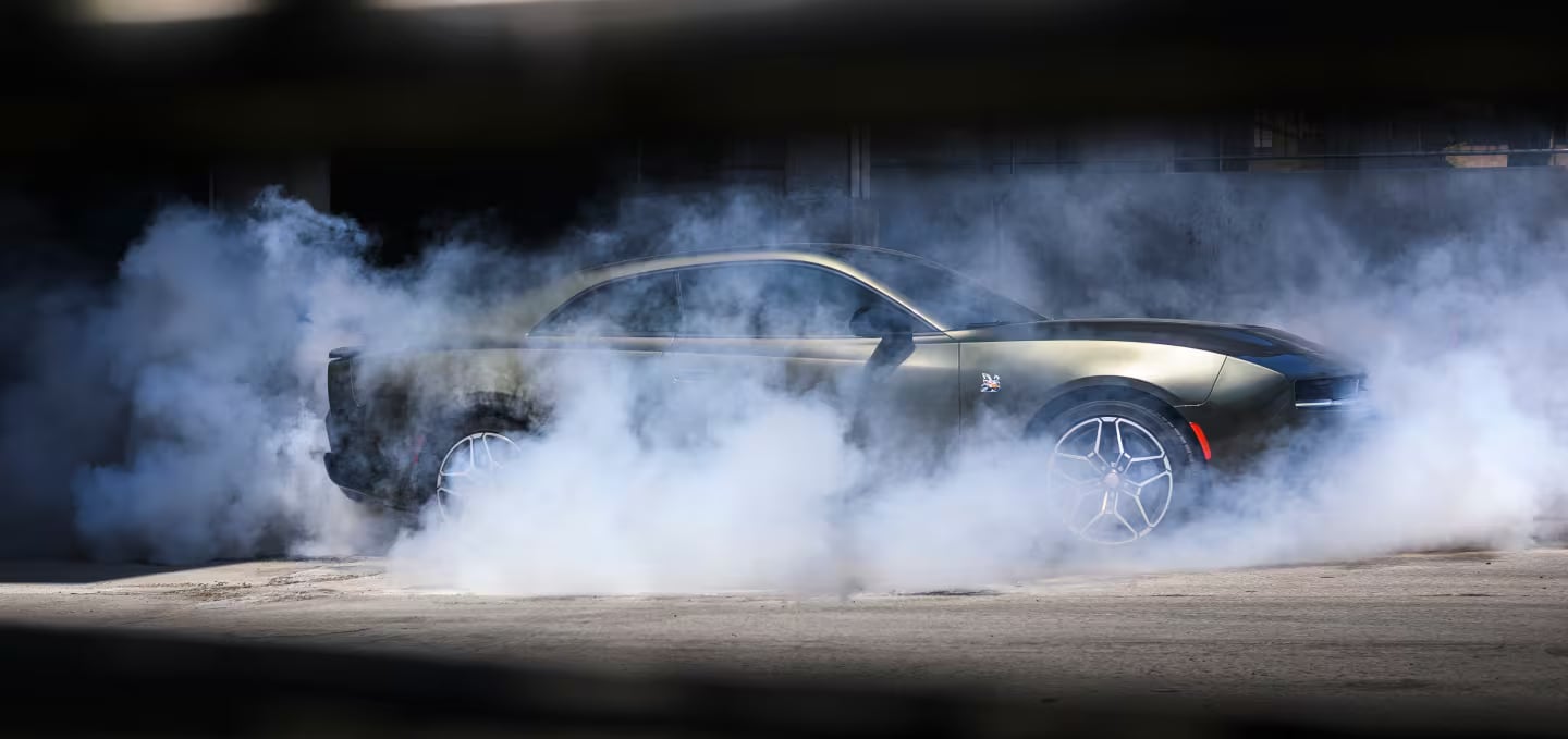 Dodge Charger performing a burnout on a closed course